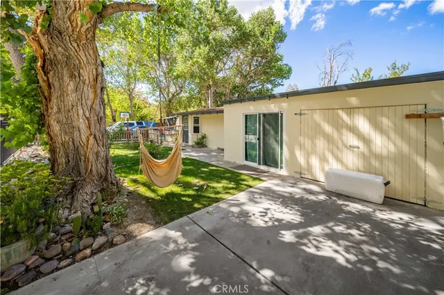 a view of a two chairs in the patio