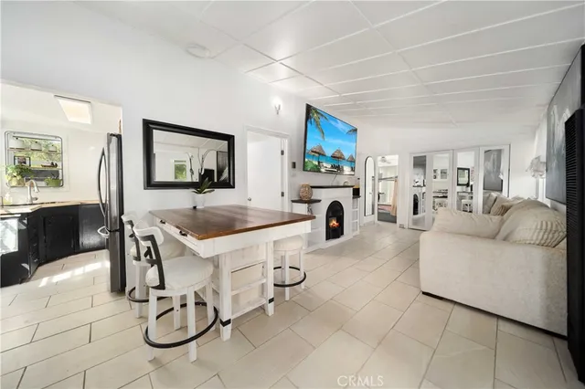 a view of living room kitchen with furniture and fireplace