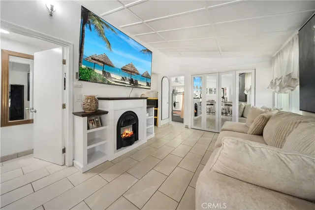 a living room with furniture a fireplace and a flat screen tv