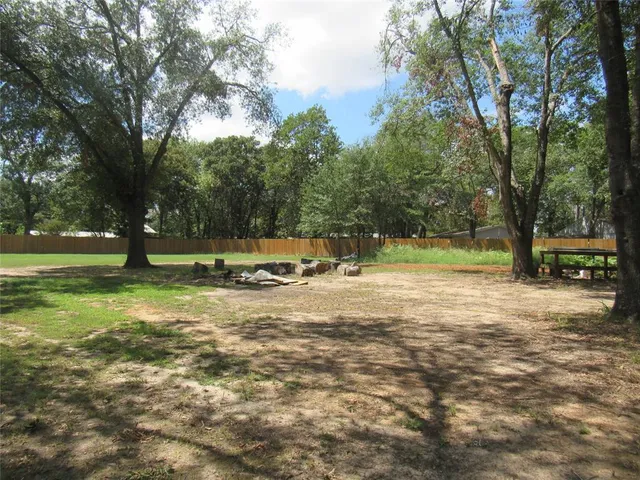 a view of a yard with a tree