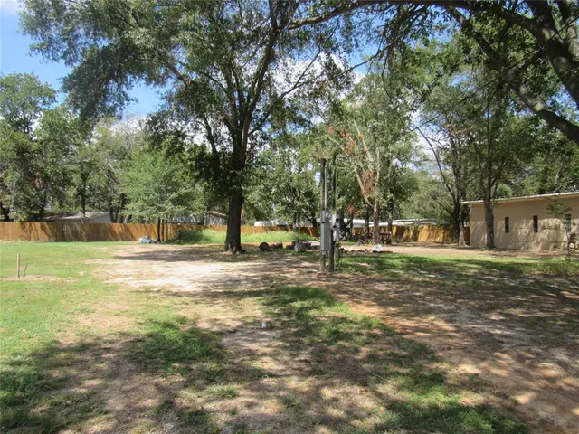 a view of a yard with a tree