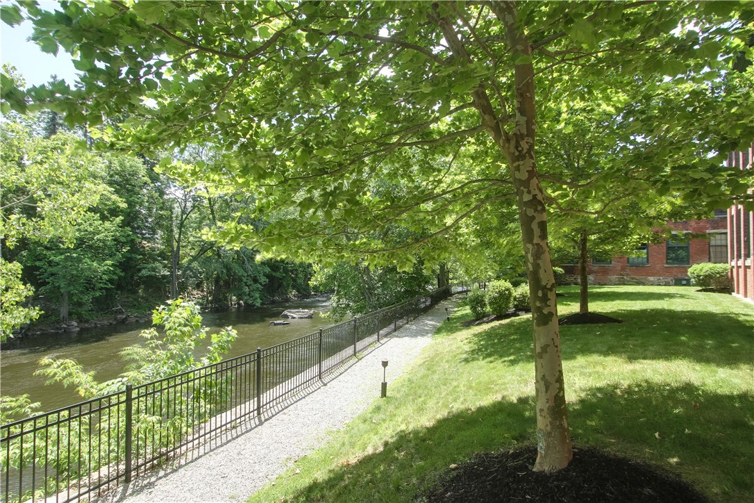 99 Allen Street, Unit 117 Woonsocket, RI 02895 - Photo 21 of 25 Looking over the Blackstone River from the grounds of the Lofts at Allen Street.