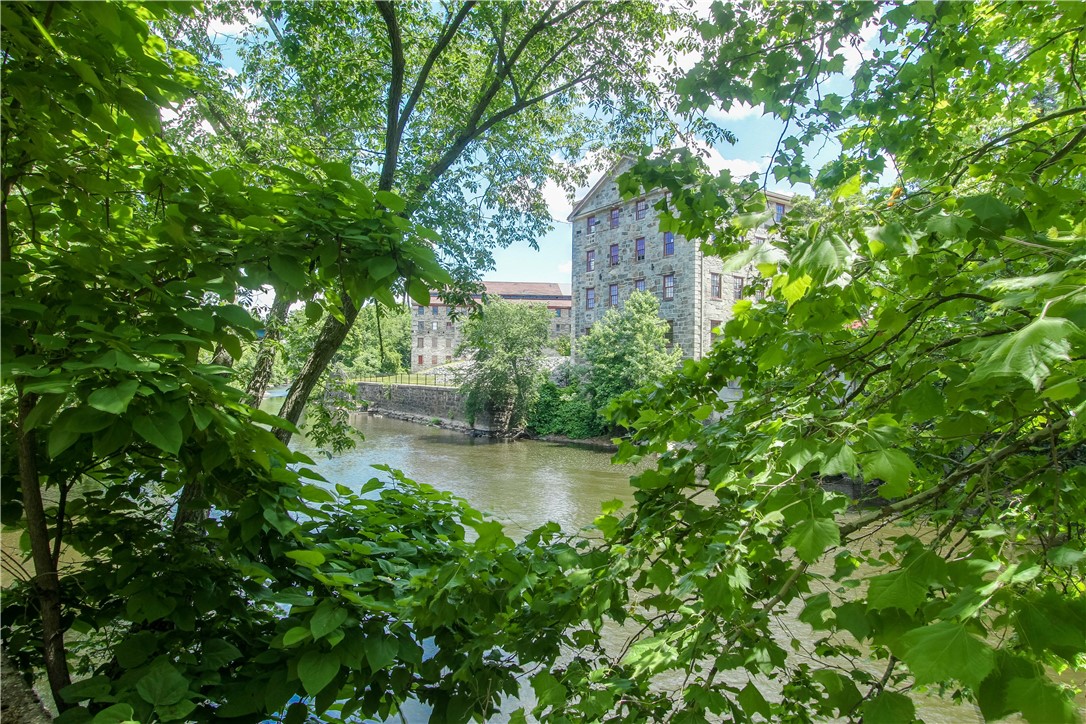 99 Allen Street, Unit 117 Woonsocket, RI 02895 - Photo 24 of 25 Another view across the river from the grounds of the Lofts at Allen Street.