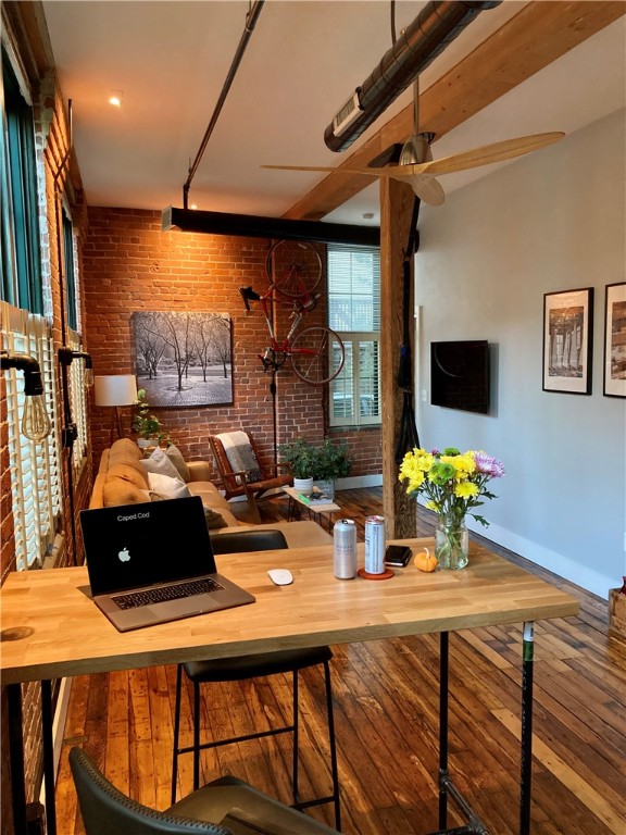 99 Allen Street, Unit 117 Woonsocket, RI 02895 - Photo 5 of 25 Looking from the kitchen into the Den. Note the exposed brick and wooden beams, the variable nature of the hardwoods and the oversized windows.