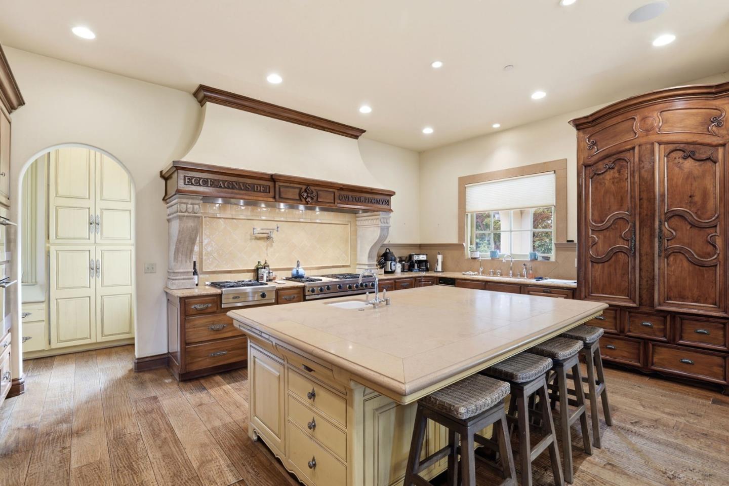 505 Gordon Avenue San Jose, CA 95127 - Photo 12 of 62 a kitchen with stainless steel appliances granite countertop a stove a refrigerator and a dining table with wooden floors