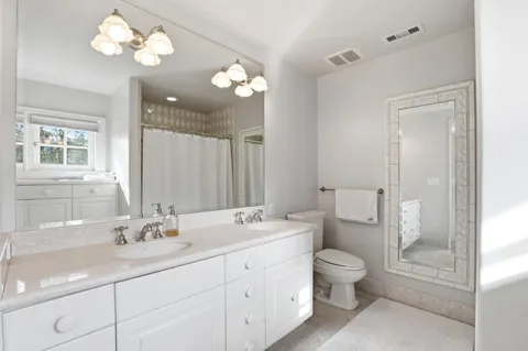 a spacious bathroom with a bathtub and sink