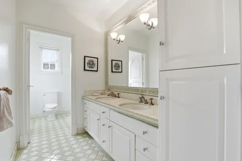 a bathroom with a toilet sink and shower