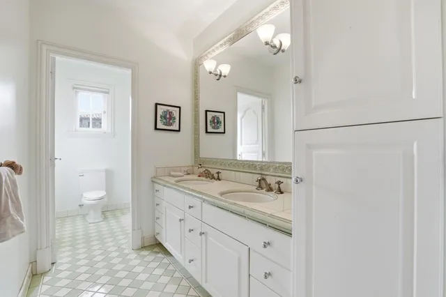 a bathroom with a toilet sink and shower