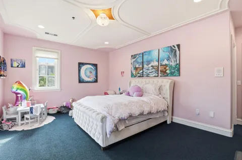 a dining room with furniture and a window