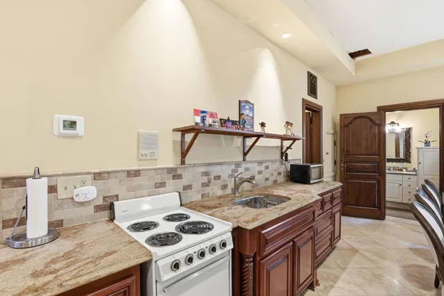 a front view of a house with a yard table and chairs