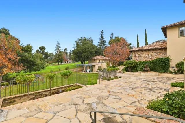 a view of a house with swimming pool and sitting area