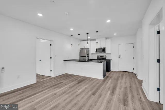 a view of kitchen with wooden floor