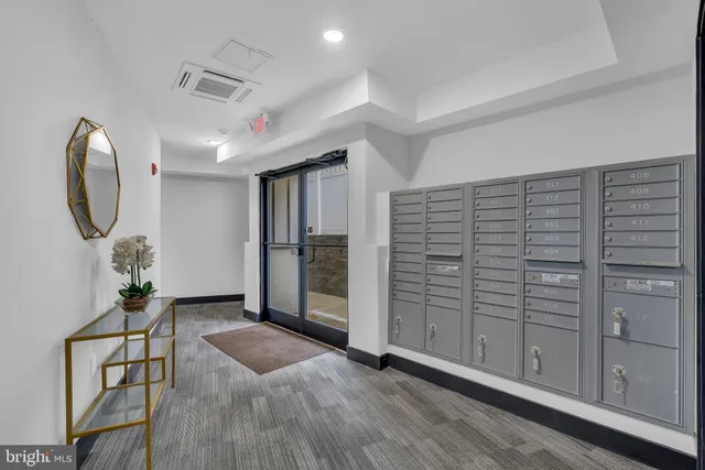 a view of a room with wooden floor staircase and a bathroom