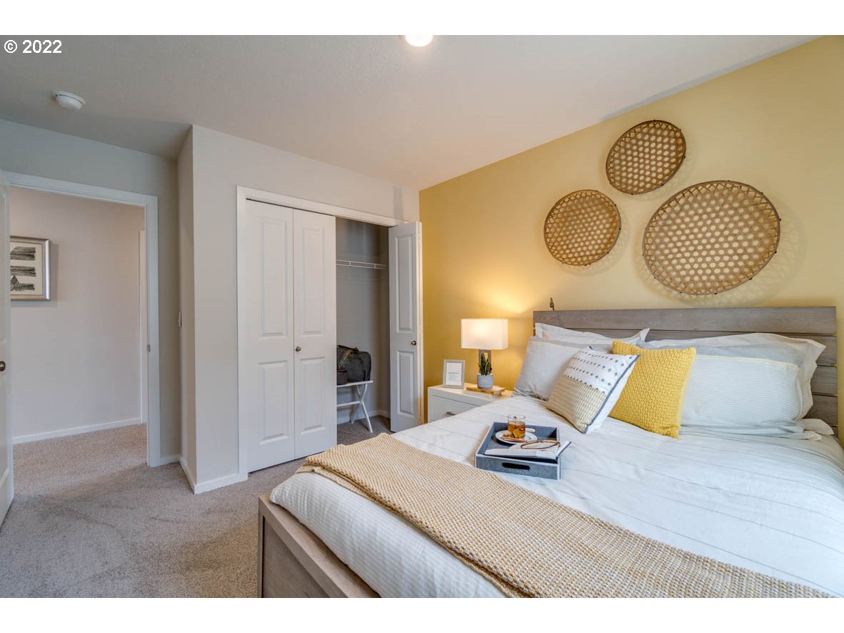 2402 Halter Drive Woodburn, OR 97071 - Photo 25 of 31 a bedroom with a bed and wooden floor