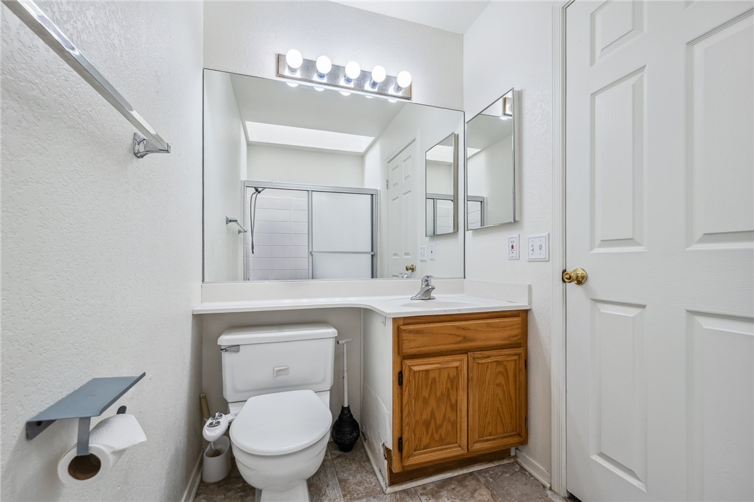 2524 South Ridge Avenue Bullhead City, AZ 86429 - Photo 41 of 64 Full bathroom with vanity, toilet, baseboards, and a shower