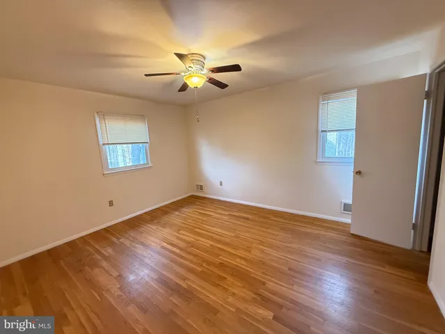 a view of an empty room and wooden floor