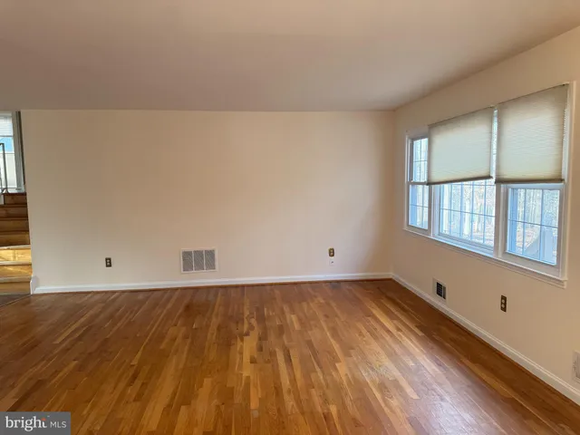 a view of wooden floor and windows in a room