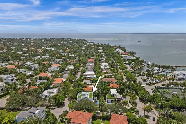 a kitchen with a refrigerator a sink and a stove top oven