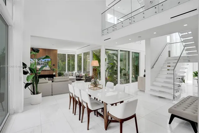a living room with furniture potted plant and a large window