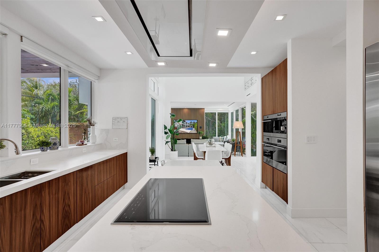 201 Buttonwood Drive Key Biscayne, FL 33149 - Photo 19 of 80 a large white kitchen with large windows and refrigerator