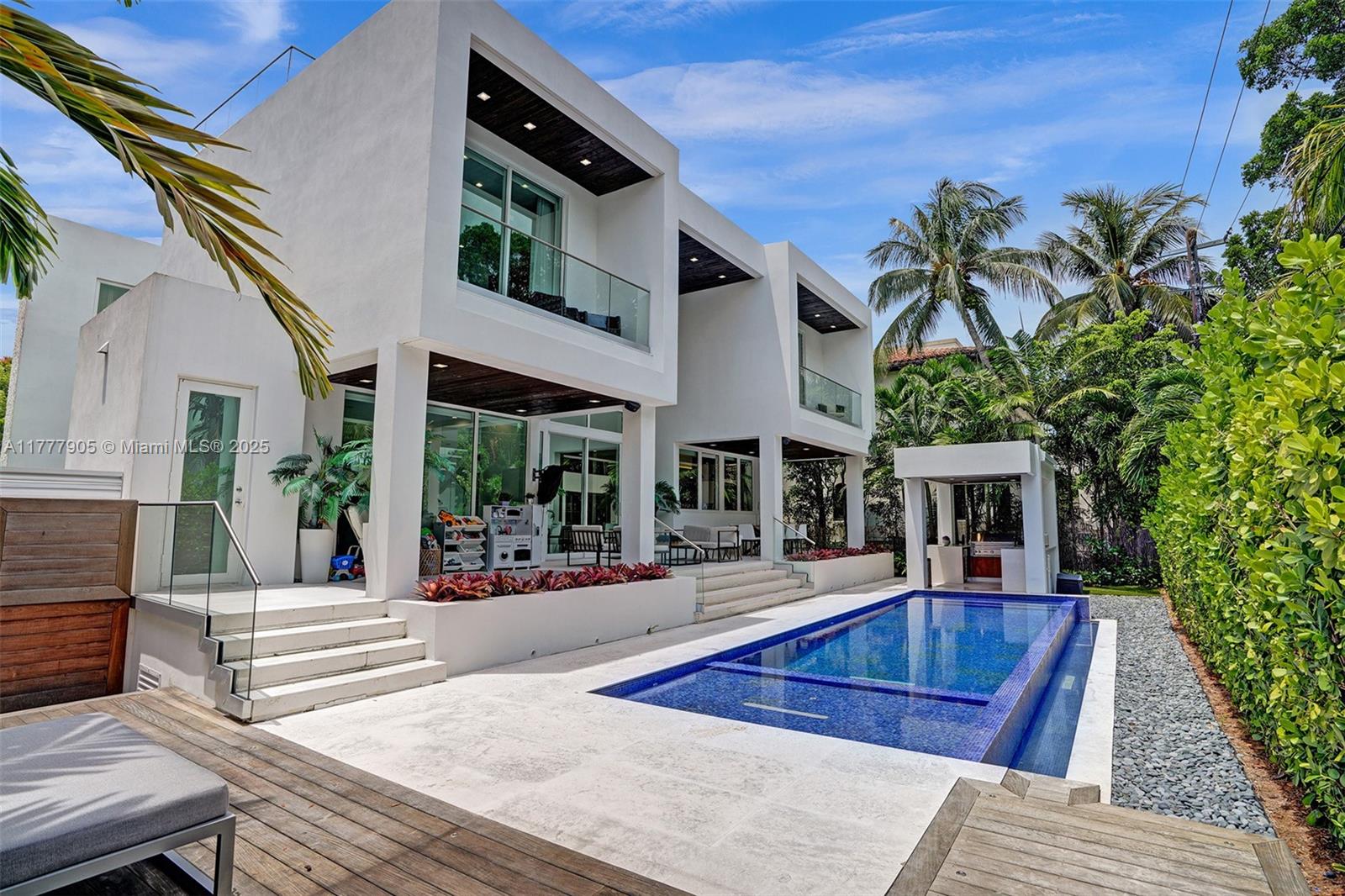 201 Buttonwood Drive Key Biscayne, FL 33149 - Photo 30 of 80 front view of a house with a swimming pool