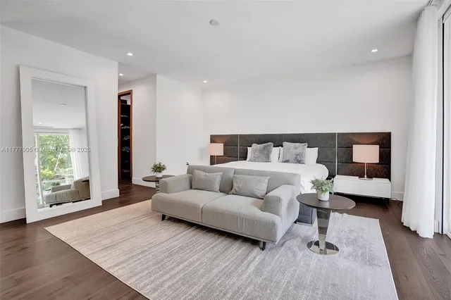 a bedroom with a large bed and a couch