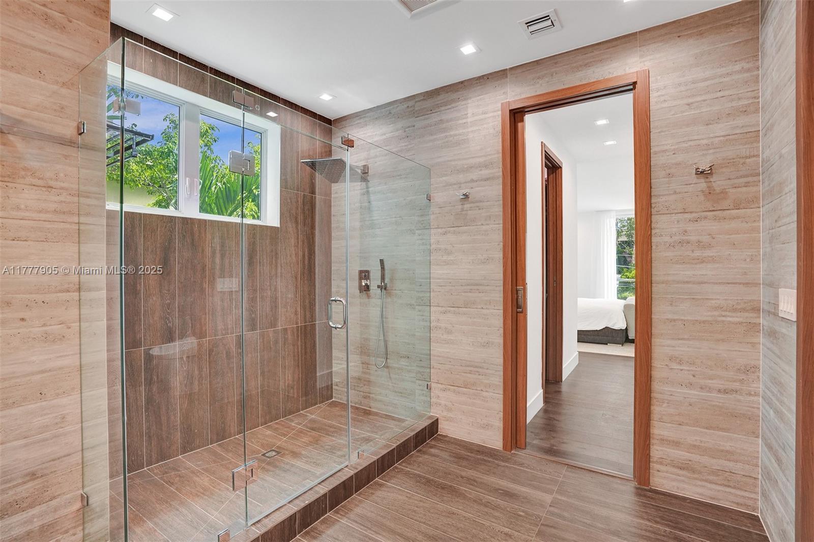 201 Buttonwood Drive Key Biscayne, FL 33149 - Photo 41 of 80 a bathroom with a glass door shower and a sink