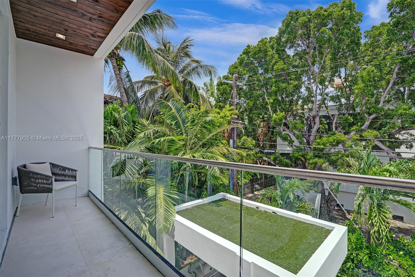 201 Buttonwood Drive Key Biscayne, FL 33149 - Photo 44 of 80 a view of a balcony with chair and table