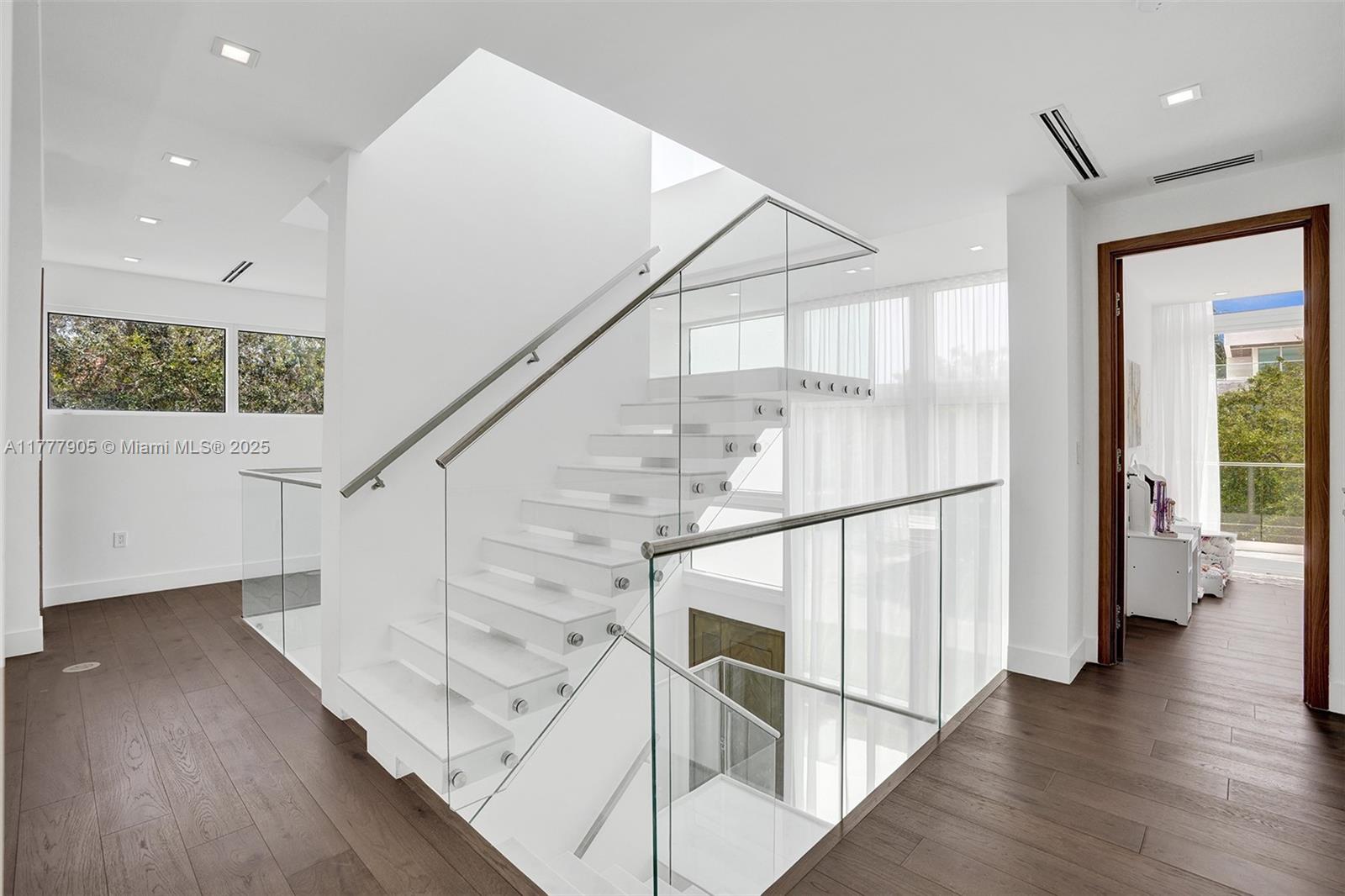 201 Buttonwood Drive Key Biscayne, FL 33149 - Photo 46 of 80 a view of entryway with wooden floor and stairs