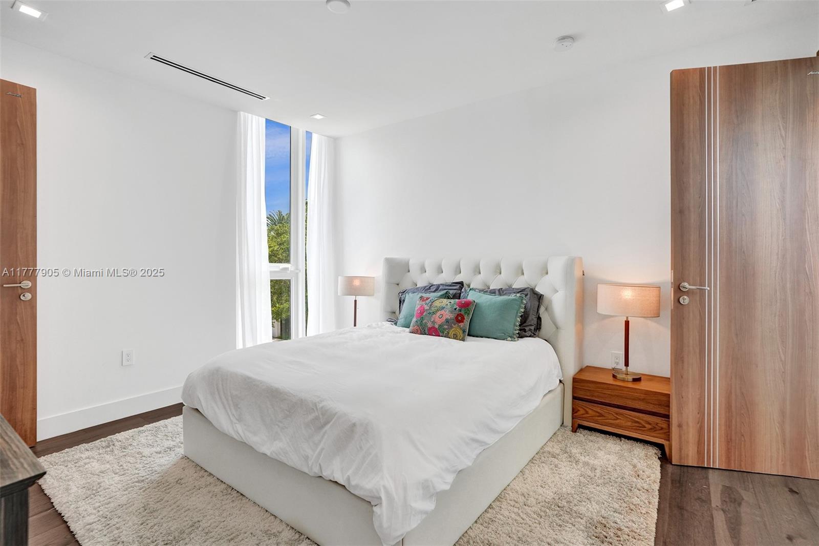 201 Buttonwood Drive Key Biscayne, FL 33149 - Photo 53 of 80 a bedroom with a bed and a night stand