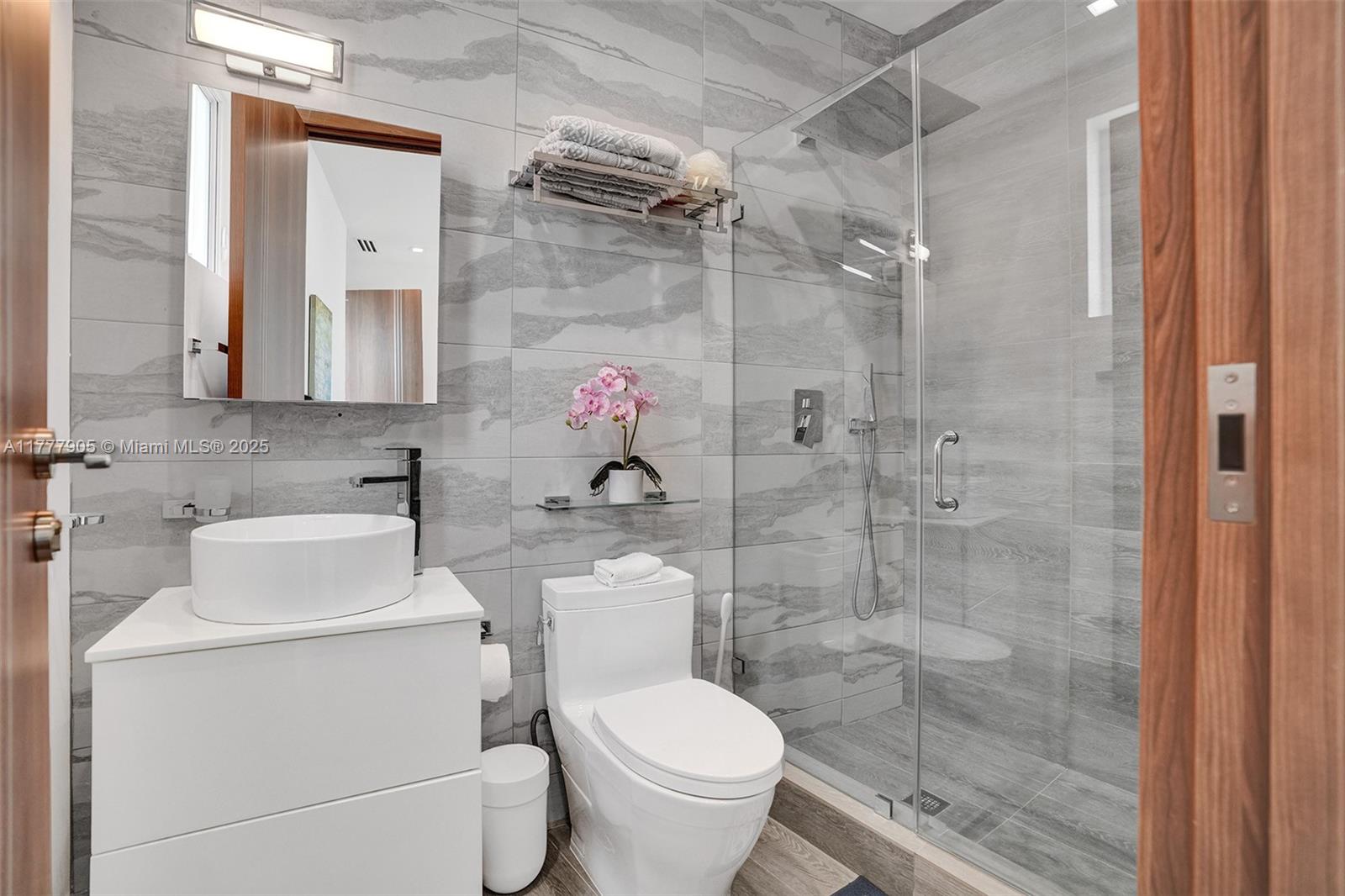 201 Buttonwood Drive Key Biscayne, FL 33149 - Photo 54 of 80 a bathroom with a toilet sink and shower