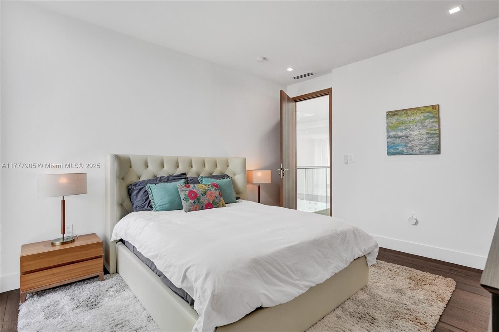 201 Buttonwood Drive Key Biscayne, FL 33149 - Photo 55 of 80 a bedroom with a bed and a lamp