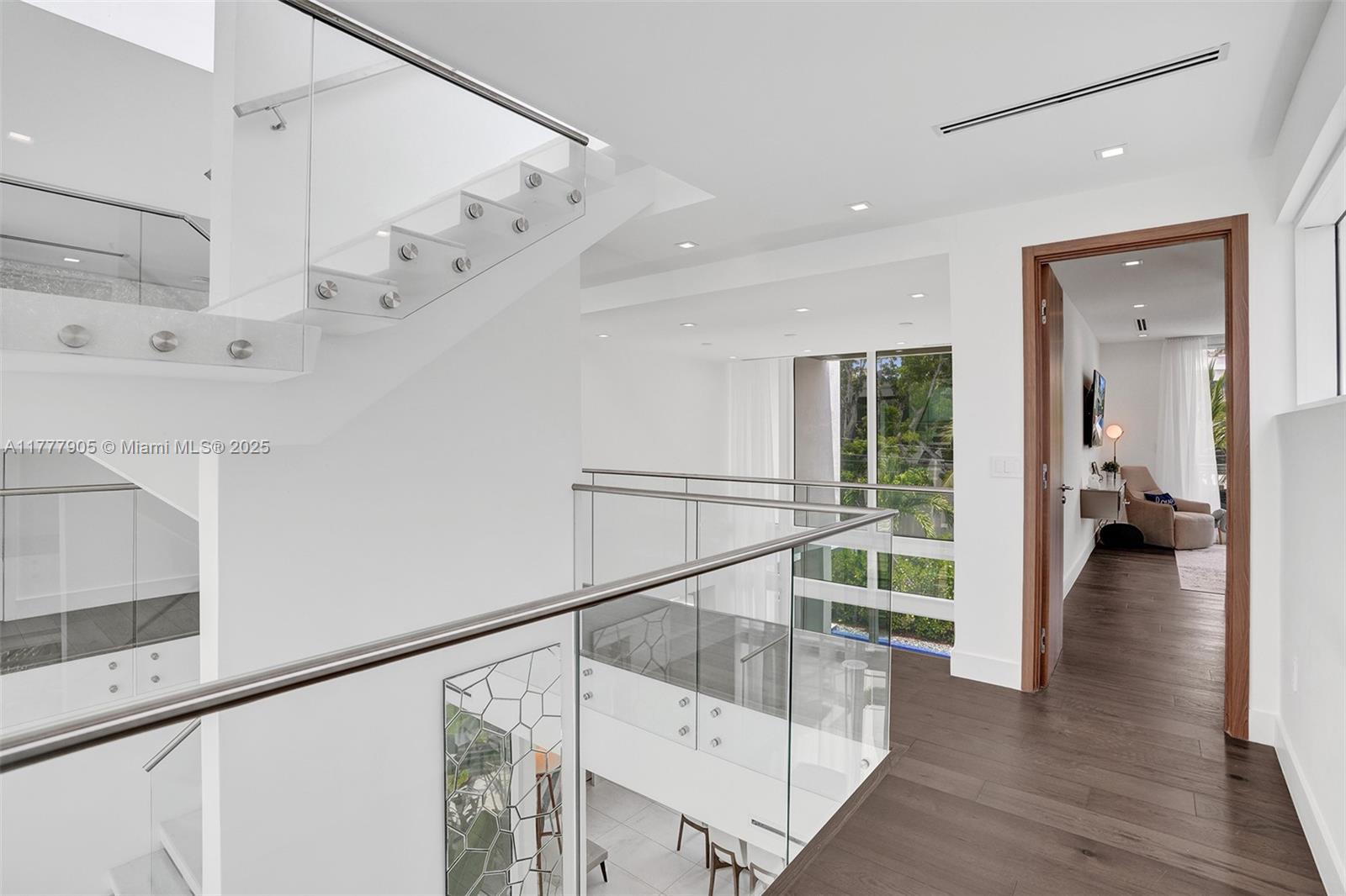 201 Buttonwood Drive Key Biscayne, FL 33149 - Photo 57 of 80 a view of a hallway with wooden floor and staircase