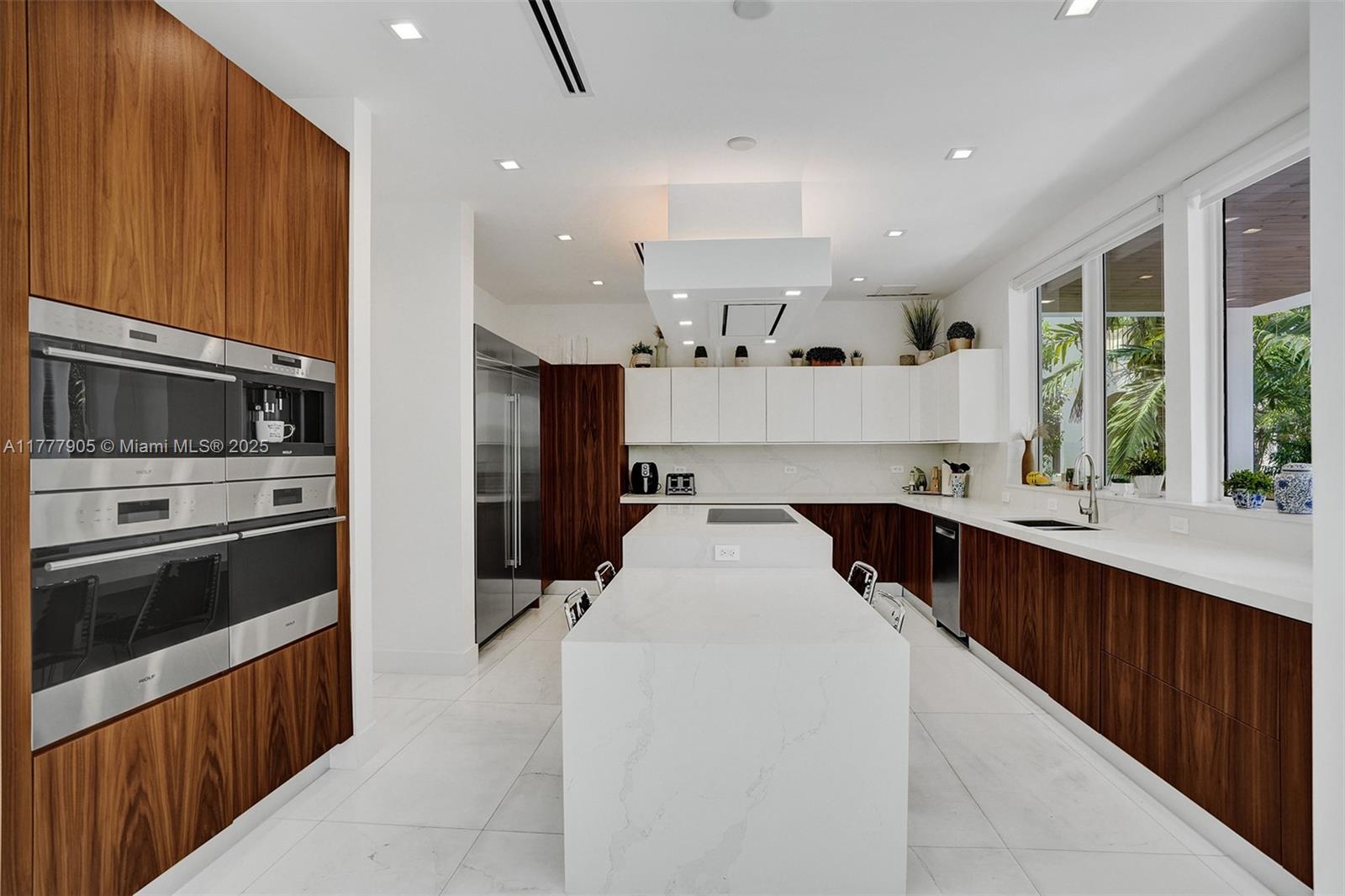 201 Buttonwood Drive Key Biscayne, FL 33149 - Photo 8 of 80 a kitchen with stainless steel appliances a sink stove and cabinets