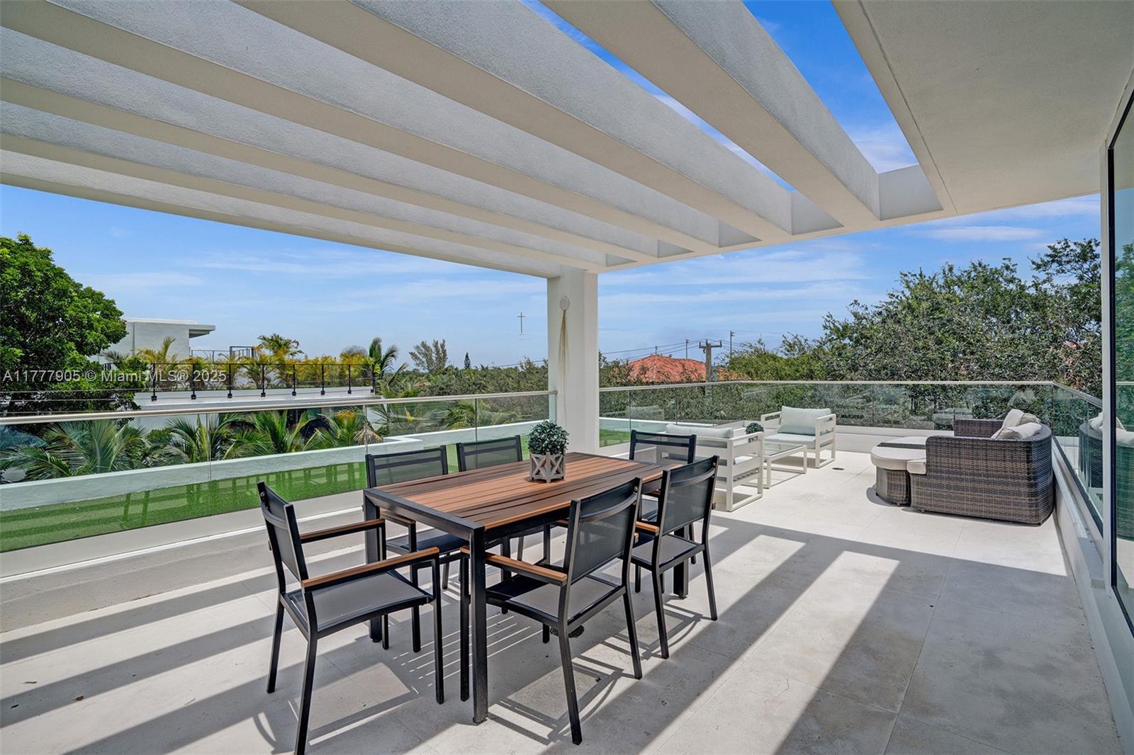 201 Buttonwood Drive Key Biscayne, FL 33149 - Photo 10 of 80 a view of a patio with a dining table and chairs