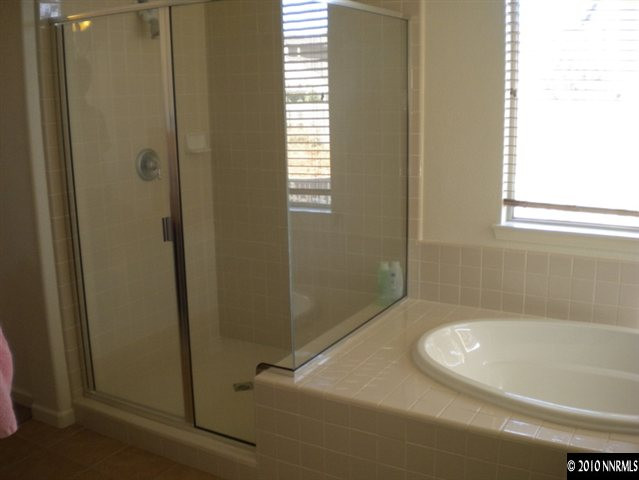 14046 Tagor Road Reno, NV 89521 - Photo 5 of 6 a bathroom with a bathtub and shower
