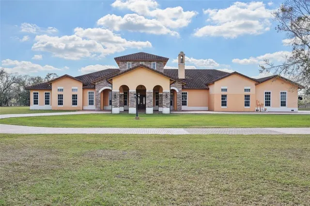 a front view of a house with swimming pool and porch