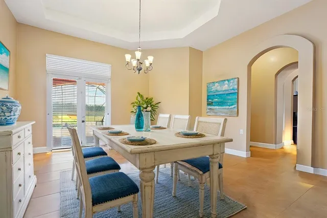 a living room with furniture a window and a chandelier