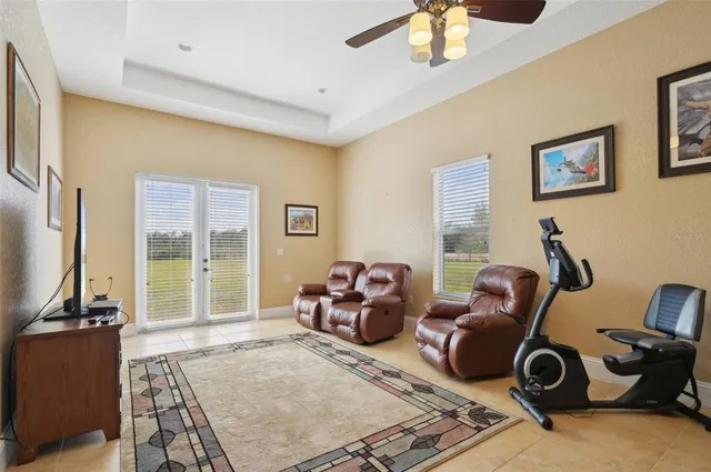 a bedroom with a bed and large windows