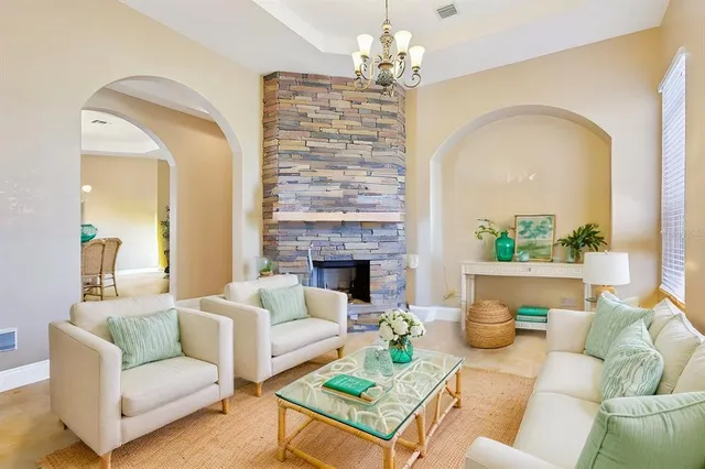 a living room with furniture a fireplace and window
