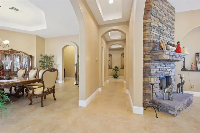 a large kitchen with kitchen island granite countertop wooden cabinets a granite counter and a sink