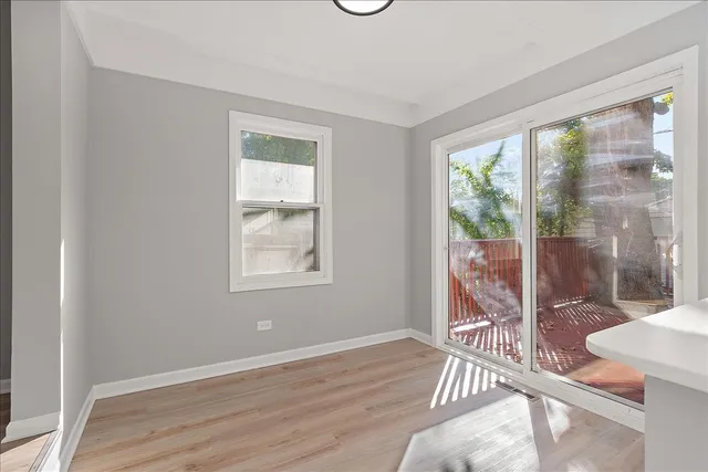 a view of a room with wooden floor and windows