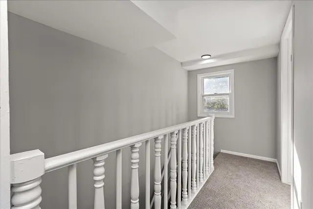 a view of hallway with wooden floor