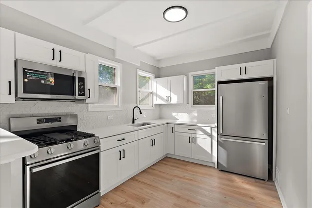 a kitchen with a refrigerator stove and microwave