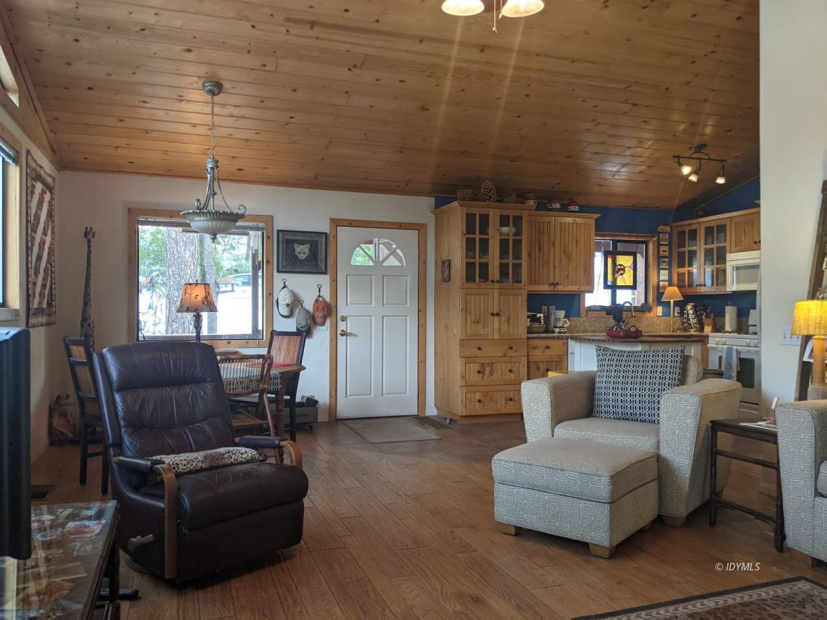 52790 Idyllmont Road Idyllwild, CA 92549 - Photo 12 of 65 a living room with furniture and a chandelier