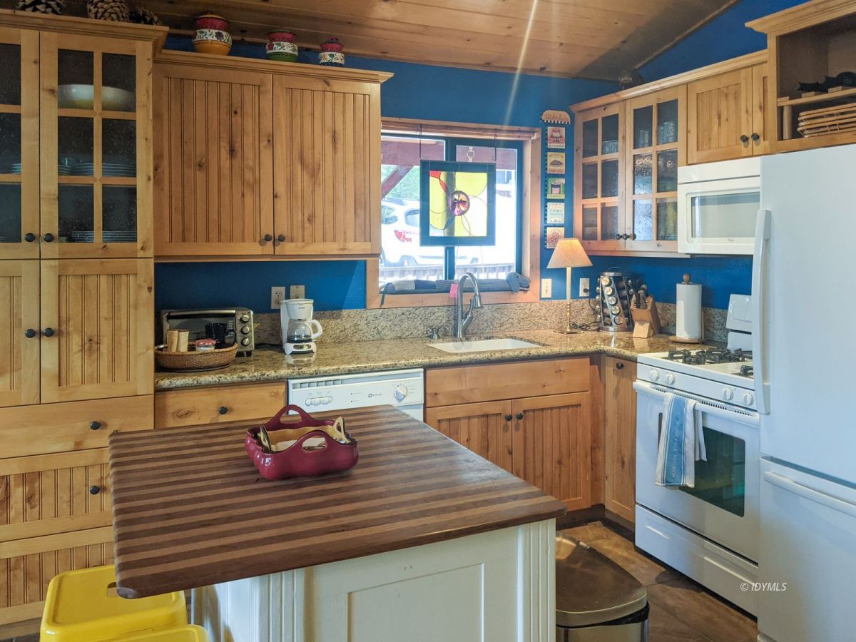 52790 Idyllmont Road Idyllwild, CA 92549 - Photo 23 of 65 a kitchen with a sink stove and cabinets