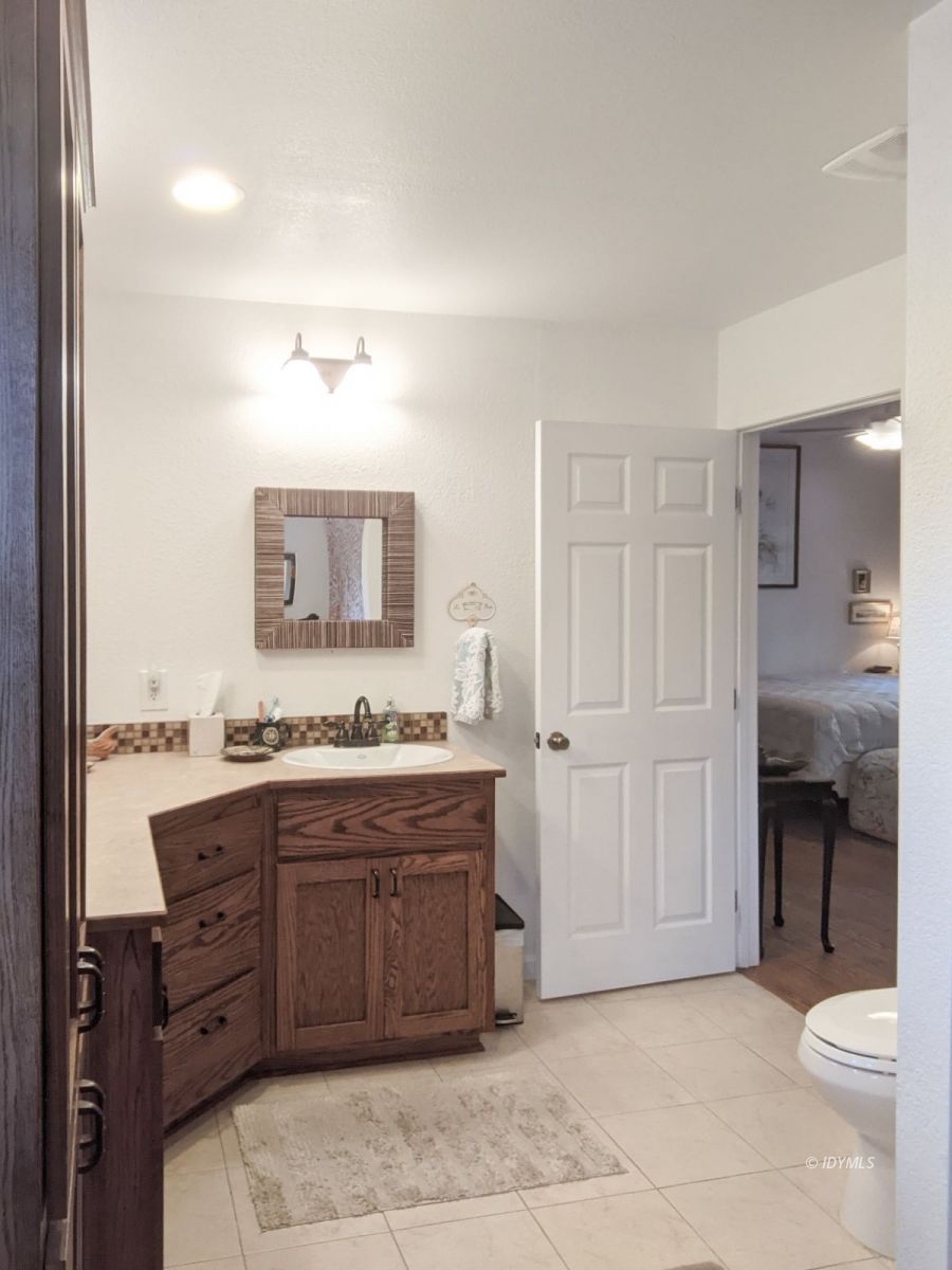 52790 Idyllmont Road Idyllwild, CA 92549 - Photo 44 of 65 a bathroom with a granite countertop sink and a mirror