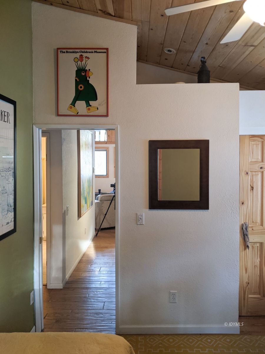 52790 Idyllmont Road Idyllwild, CA 92549 - Photo 49 of 65 a view of a hallway with wooden floor and a livingroom