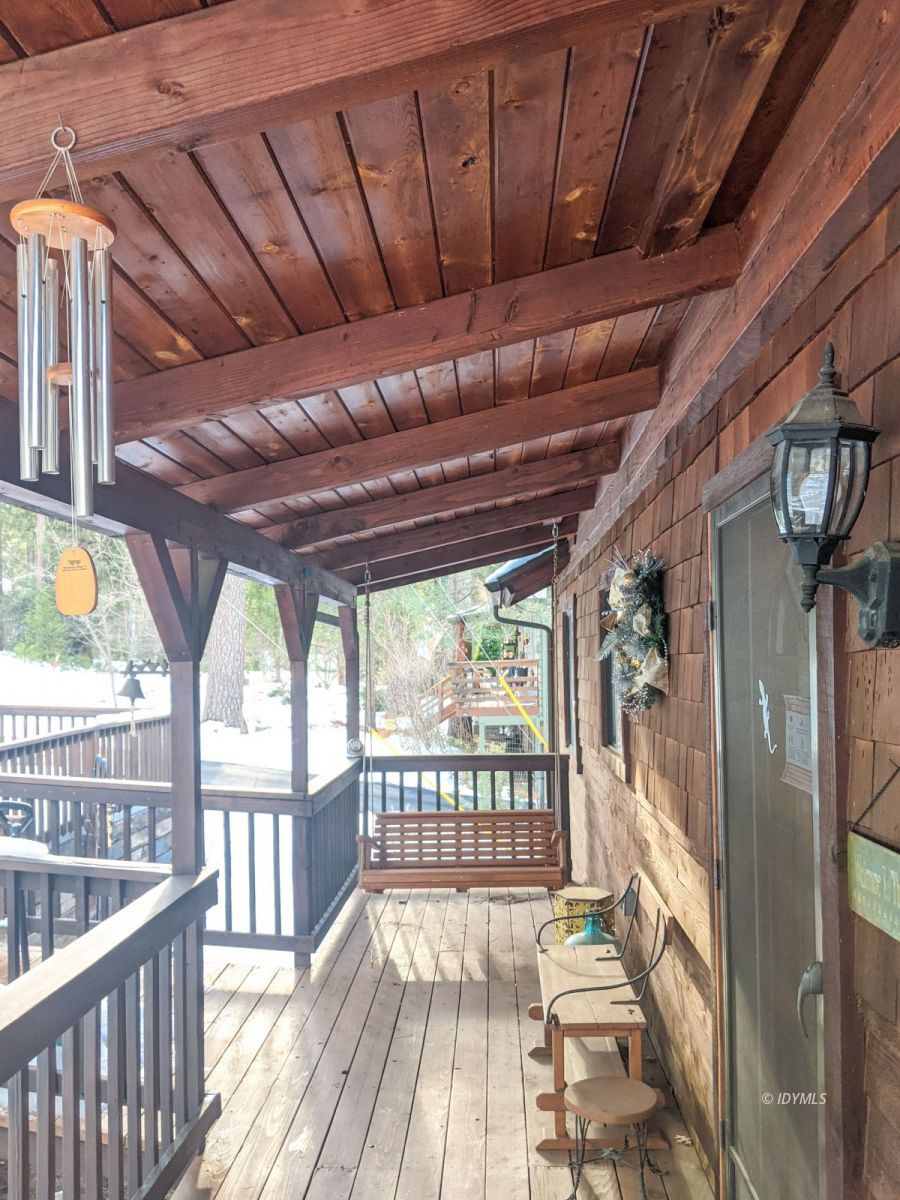 52790 Idyllmont Road Idyllwild, CA 92549 - Photo 7 of 65 a view of a porch with wooden floor