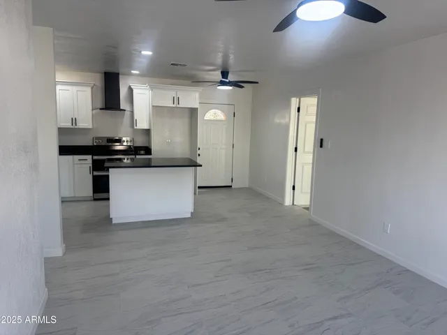 a kitchen with stainless steel appliances granite countertop a stove and a refrigerator